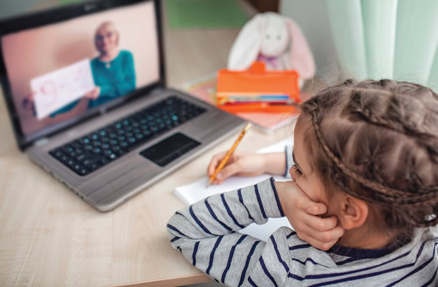 child distant learning on laptop