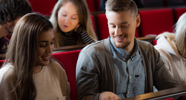 Group of students seated next to each other. 