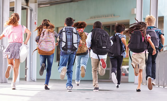 Children running in a school hallway